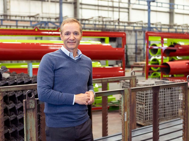 DJ Eihusen of the Kansas City Fed's Omaha Branch Board of Directors standing in front of pipes.